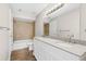 Bright bathroom featuring double sink vanity with granite countertop and a bathtub with beige tiling at 5788 Devon St, Port Orange, FL 32127
