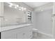 Bright bathroom showcasing vanity with marble countertop and walk-in shower at 5788 Devon St, Port Orange, FL 32127