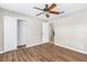 Bedroom with wood-look floors and sliding-door closet at 5788 Devon St, Port Orange, FL 32127