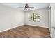 Bedroom with wood-look floors and a bright window with wooded view at 5788 Devon St, Port Orange, FL 32127