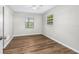 Bedroom with wood-look floors and bright windows at 5788 Devon St, Port Orange, FL 32127