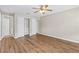 Bedroom with wood-look floors, a ceiling fan, and a closet with sliding doors at 5788 Devon St, Port Orange, FL 32127