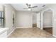 Bright dining area with tile floor, window, and arched doorway to the living room at 5788 Devon St, Port Orange, FL 32127