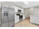 Well lit kitchen showcasing stainless steel appliances, white cabinets, and tile flooring at 5788 Devon St, Port Orange, FL 32127