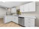 Bright kitchen featuring stainless steel appliances, white cabinets, and modern countertops at 5788 Devon St, Port Orange, FL 32127