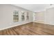Bright living room featuring wood flooring and natural light from large windows at 5788 Devon St, Port Orange, FL 32127