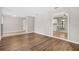 Open-concept living space with wood flooring, tile entryway, and views into kitchen area at 5788 Devon St, Port Orange, FL 32127