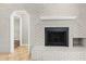 Close-up of painted brick fireplace, tile floor, and passage to other rooms at 5788 Devon St, Port Orange, FL 32127