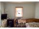 Modest bedroom featuring twin bed sets, side dresser and natural light at 580 Ronnoc Ln, New Smyrna Beach, FL 32168