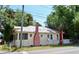 Charming single-story home featuring a brick chimney and mature trees, with a fenced yard at 580 Ronnoc Ln, New Smyrna Beach, FL 32168
