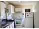 Functional kitchen with white appliances, ample cabinet space, and good natural light at 580 Ronnoc Ln, New Smyrna Beach, FL 32168