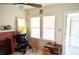 Brightly lit interior with a red brick fireplace and view into porch at 580 Ronnoc Ln, New Smyrna Beach, FL 32168