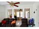 Open living space with tile floors, a comfortable brown sofa, and views to kitchen at 580 Ronnoc Ln, New Smyrna Beach, FL 32168