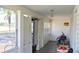 Enclosed porch with bright light and a variety of household items at 580 Ronnoc Ln, New Smyrna Beach, FL 32168