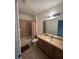 Cozy bathroom featuring a tub with shower, a wooden vanity and tile flooring at 6043 Strada Isle Way, Orlando, FL 32835