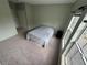 Bedroom with light-green walls, plush carpet, and natural light from two windows at 6043 Strada Isle Way, Orlando, FL 32835