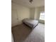 Bedroom features plush carpet, white walls, and a window for natural light at 6043 Strada Isle Way, Orlando, FL 32835