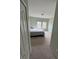 Bedroom with plush carpeting, light-green walls, and natural light from two windows at 6043 Strada Isle Way, Orlando, FL 32835