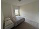 Bright bedroom with plush carpet and a sunlit window at 6043 Strada Isle Way, Orlando, FL 32835