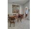 Inviting dining area features tile flooring, multiple wood tables, and chairs, perfect for gatherings and casual meals at 6043 Strada Isle Way, Orlando, FL 32835