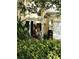 Townhouse front entry with a white pergola and landscaping at 6043 Strada Isle Way, Orlando, FL 32835