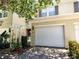 Townhouse with a two-car garage and a beautifully landscaped front yard at 6043 Strada Isle Way, Orlando, FL 32835
