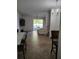 Open-concept living area with tile flooring, leading to the dining area and rear patio at 6043 Strada Isle Way, Orlando, FL 32835