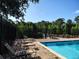 Sparkling community pool with lounge chairs and a brick patio area at 6043 Strada Isle Way, Orlando, FL 32835
