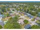 Panoramic aerial view of a suburban neighborhood featuring lush trees, pools and sidewalks at 612 Moonpenny Cir, Port Orange, FL 32127