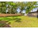 Large backyard featuring new fence and plenty of green space, as well as a shed and screened patio at 612 Moonpenny Cir, Port Orange, FL 32127
