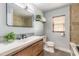 Modern bathroom featuring a dual sink vanity, tiled shower, and wood-look tile floors at 612 Moonpenny Cir, Port Orange, FL 32127