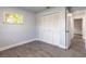 Bedroom with wood-look tile flooring, closet and neutral paint at 612 Moonpenny Cir, Port Orange, FL 32127
