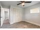 Comfortable bedroom with wood-look tile floors, neutral walls, and a closet for storage at 612 Moonpenny Cir, Port Orange, FL 32127