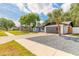 Lovely single-story home with a modern gray garage door, blue entry door, and manicured lawn at 612 Moonpenny Cir, Port Orange, FL 32127