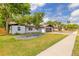 Beautiful home featuring a well-maintained lawn, modern garage door, and clean landscaping at 612 Moonpenny Cir, Port Orange, FL 32127