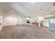 Open layout featuring living, dining, and kitchen with wood-look tile floors at 612 Moonpenny Cir, Port Orange, FL 32127