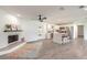 Open-concept living room featuring a fireplace, island, and modern ceiling fan at 612 Moonpenny Cir, Port Orange, FL 32127