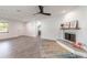 Modern living room featuring a fireplace and wood-look tile flooring at 612 Moonpenny Cir, Port Orange, FL 32127