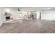 Open-concept living room featuring a fireplace, island, and wood-look tile flooring at 612 Moonpenny Cir, Port Orange, FL 32127