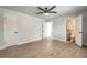 Spacious main bedroom with wood-look tile floors, neutral walls, and ensuite bathroom at 612 Moonpenny Cir, Port Orange, FL 32127