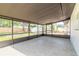 Large screened patio with tile flooring offering an unobstructed view of the large backyard and new fence at 612 Moonpenny Cir, Port Orange, FL 32127