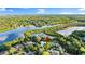 Breathtaking aerial view of the property with the house surrounded by lush trees and a tranquil river at 6317 Palmas Bay Cir, Port Orange, FL 32127