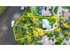 Aerial view outlining property boundaries, showcasing lush landscape, waterfront access and a private dock at 6317 Palmas Bay Cir, Port Orange, FL 32127