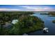 Breathtaking aerial view of a home nestled amidst lush greenery and serene waterfront, showcasing its private dock at 6317 Palmas Bay Cir, Port Orange, FL 32127
