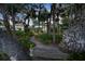 Scenic backyard view of a two-story home with lush landscaping, and private outdoor kitchen at 6317 Palmas Bay Cir, Port Orange, FL 32127