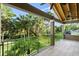 Relax on the balcony with a green railing and enjoy the expansive views of the lush landscaping and mature palm trees at 6317 Palmas Bay Cir, Port Orange, FL 32127