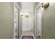 Hallway view of Jack and Jill bathroom featuring tiled floors and glass block shower at 6317 Palmas Bay Cir, Port Orange, FL 32127