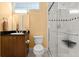 Bathroom featuring a single sink vanity, a toilet, and a glass enclosed tiled shower at 6317 Palmas Bay Cir, Port Orange, FL 32127