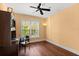 Bedroom with a ceiling fan, built-in desk, natural light, and hardwood floors at 6317 Palmas Bay Cir, Port Orange, FL 32127