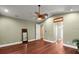Spacious bedroom featuring a ceiling fan, hardwood floors, neutral walls and a view of the ensuite bathroom at 6317 Palmas Bay Cir, Port Orange, FL 32127